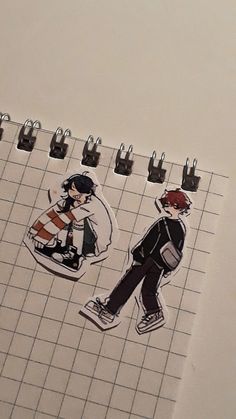 an open notebook with stickers of two people walking on the tile and one person carrying a backpack