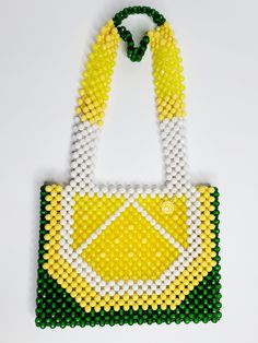 This beaded handbag is a true original! At approx. 9"X 8"X 2" It's the perfect size for your phone, keys and cards.  The 20" strap is great for over the shoulder and nestles high and securely.  Also a wonderful length to carry by handle down by the hip.  Made of acrylic beads, so its super easy to handwash when needed.  Made by Lora Rolling.  Ships to US (only) via USPS.  Arrives within 7 days! All sales are final. Questions? Text 214-872-0062 Beaded Tote Shoulder Bag, Everyday Beaded Tote Shoulder Bag, Everyday Beaded Rectangular Shoulder Bag, Everyday Beaded Shoulder Bag, Square Beaded Bag For Everyday Use, Yellow Beaded Rectangular Bag, Everyday Beaded Crossbody Shoulder Bag, Green Beaded Shoulder Bag For Everyday Use, Green Beaded Shoulder Bag For Daily Use