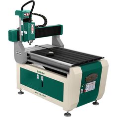 a machine that is sitting on top of a white surface with a green and black handle