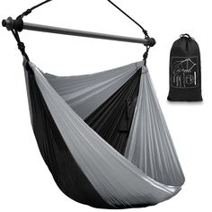 a black and white photo of a hammock with a drawsack bag next to it