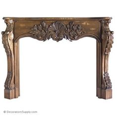 an ornate fireplace mantel with carvings on the top and sides, made of wood