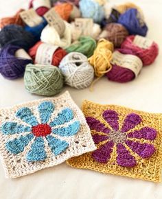 two crocheted coasters are sitting next to each other