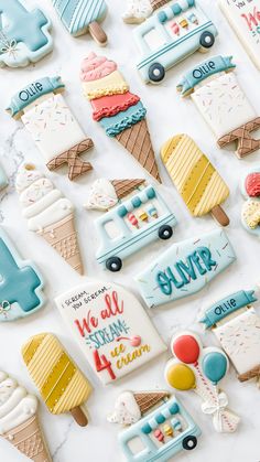 decorated cookies are displayed on a table with the words we all have ice cream written on them