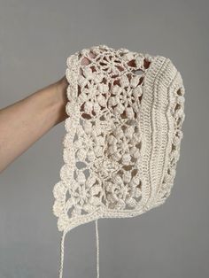 a crocheted purse being held by a hand