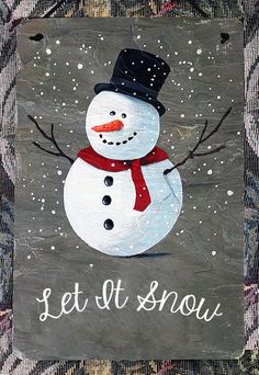 a snowman painted on the side of a building with words let it snow written in white