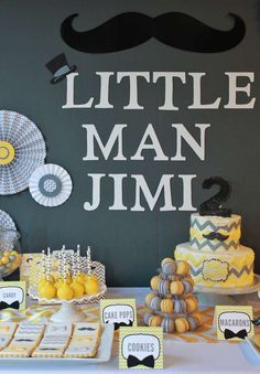 a table topped with cakes and desserts covered in yellow and white frosted icing