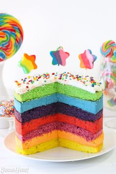 a rainbow cake with sprinkles and stars on top