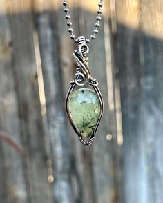 Beautiful Prehnite Pendant wrapped in solid sterling silver from Rio Grande! Full pendant measure about 0.62 inches wide and 2.11 inches tall *Prehnite is a  very versatile stone and has several benefits. It has been said to promote inner peace and spiritual growth, enhance intuition and psychic abilities, help with dream recall and/or lucid dreaming and is a powerful stone for manifestation.  *This piece has been carefully hand wrapped with sterling silver and then oxidized and polished to a hi Handmade Peridot Pendant Jewelry, Green Freeform Jewelry For Gifts, Spiritual Healing Jewelry Made Of Prehnite, Unique Green Tourmaline Jewelry, Chrysoprase Jewelry With Large Stone For Gift, Green Tourmaline Teardrop Jewelry, Gift Prehnite Gemstone Jewelry, Healing Hand-wrapped Moss Agate Jewelry, Artisan Green Hand Wrapped Jewelry