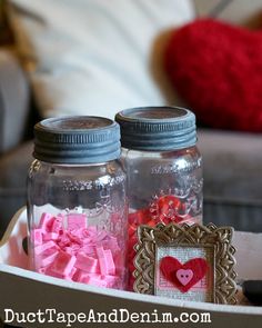 two mason jars filled with pink and red hearts