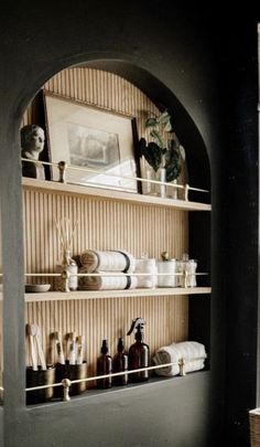 a shelf with some bottles and towels on it