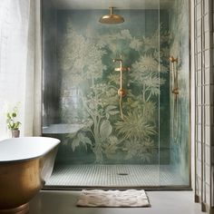 a bath room with a tub and a shower head mounted to the side of it