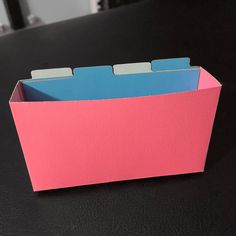 a pink and blue folder sitting on top of a table