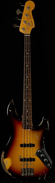 an electric bass guitar is shown against a black background