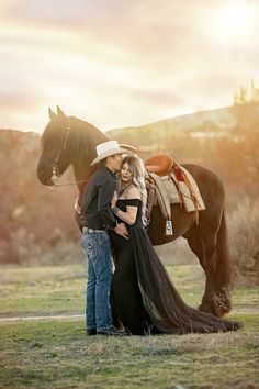 a man and woman standing next to a horse