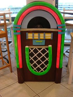 a jumbo machine sitting on top of a tiled floor next to tables and chairs