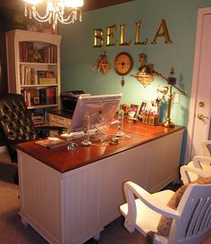 a desk with a laptop computer on top of it in front of a book shelf