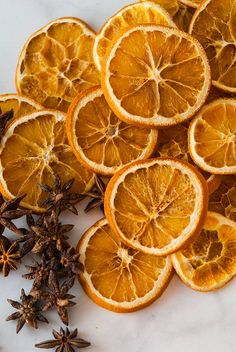 orange slices and star anise on a white surface