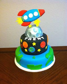 a birthday cake with a rocket ship on top