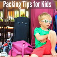 a young boy sitting on the ground next to luggage with text overlay reading packing tips for kids