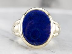 This vintage ring dates to the 1940s and has a handsome geometric, all in highly polished green gold! Particularly nice is the oval- cut lapis cabochon center, original to the piece, which makes this a truly treasured estate piece! Metal: 14K Green Gold Gem: Lapis Gem Measurements: 12.5 x 15.5 mm, Oval Ring Size: 10.50 Marks: "14" Stamped on the inside band Classic Lapis Lazuli Ring With Polished Finish, Classic Blue Oval Cabochon Signet Ring, Blue Oval Cabochon Signet Ring With Polished Finish, Formal Lapis Lazuli Oval Rings, Oval Lapis Lazuli Rings For Formal Occasions, Antique Oval Sapphire Ring With Polished Finish, Oval Modernist Signet Ring For Formal Occasions, Man Rings, Yellow Gold Sapphire Ring