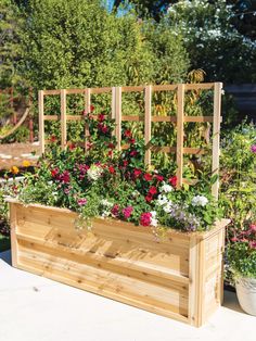 a wooden planter filled with lots of flowers