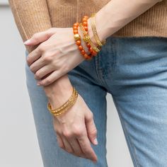 Beautiful stretch bracelet with burnt orange jade beads and single gold plated copper bead. Orange Hand-strung Carnelian Bracelets, Orange Carnelian Hand-strung Bracelets, Adjustable Gold Carnelian Beaded Bracelets, Orange Carnelian Gemstone Bead Bracelets, Gold Carnelian Beaded Bracelets For Spiritual Wear, Orange Stretch Bracelet With 8mm Beads, Orange Carnelian Beaded Bracelets, Elegant Orange Beaded Bracelets With Gemstones, Elegant Orange Gemstone Beaded Bracelets