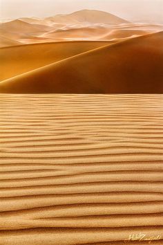 sand dunes with mountains in the background