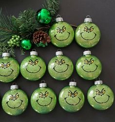 green christmas ornaments with smiley faces drawn on them