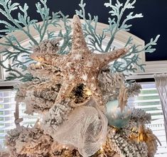 a christmas tree decorated with starfish and seashells