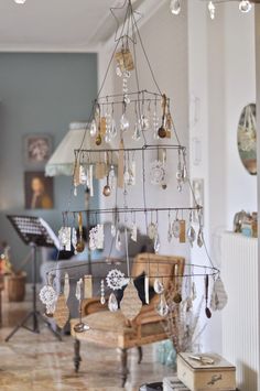 a living room filled with furniture and lots of hanging ornaments