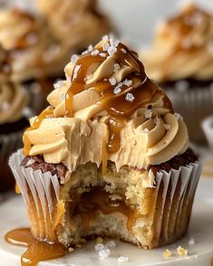 cupcakes with frosting and caramel drizzled on the top