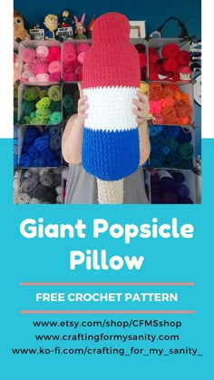 a person holding up a crochet toy with the words giant popsicle pillow