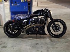 a black motorcycle parked in front of a building with zebras on it's side