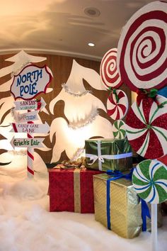 christmas decorations and presents are on display in the lobby at north pole hotel, which has been decorated with giant candy canes