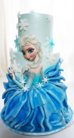 a blue and white cake with a frozen princess on top