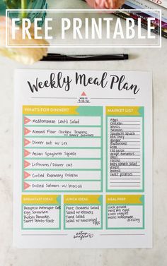 a free printable meal plan is shown on a table with flowers and books in the background