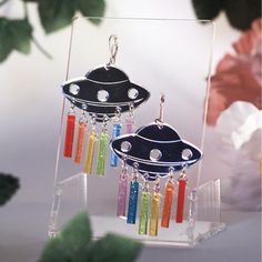 a pair of earrings with colorful beads hanging from them