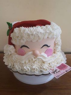 a cake shaped like santa claus on top of a bowl