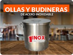 a metal bucket sitting on top of a wooden table next to a sign that reads, ollas y budineras de acero inoxidable