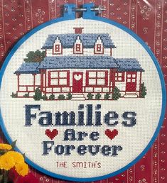 a cross stitch pattern with the words families are forever on it and flowers in front