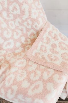 the pink and white leopard print towels are stacked on top of each other