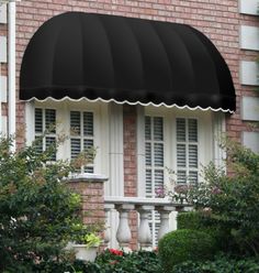 a black awning on the side of a brick building