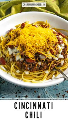 a white bowl filled with chili and cheese