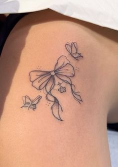 a woman's thigh with flowers and butterflies tattoo on her left side ribcage