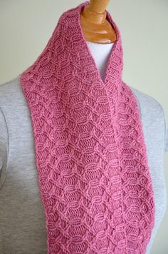 a woman wearing a pink knitted scarf