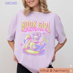 Embrace your love for reading and the summer with our "Book Girl Summer Comfort Colors Shirt"! This trendy, oversized tee is perfect for the ultimate summer-loving bookworm. Featuring a fun and whimsical design that blends your passion for books with summer vibes, this shirt is ideal for vacation trips and lazy poolside days. A perfect gift for any bookish friend or romance novel enthusiast, this tee combines comfort and style with a hint of humor. Enjoy your summer adventures with a book in one Oversized Summer Tops With Character Print, Summer Bookish T-shirt With Letter Print, Summer Graphic Print Bookish T-shirt, Spring Bookish Short Sleeve T-shirt, Spring Bookish Style Short Sleeve T-shirt, Bookish Short Sleeve T-shirt For Spring, Spring Bookish Short Sleeve Tops, Bookish Short Sleeve Tops For Spring, Cute Summer Graphic T-shirt