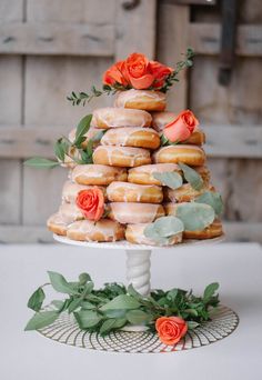 a wedding cake with donuts and roses on top is featured in this postcard