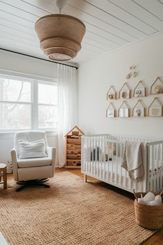 a baby's room with a white crib, rocking chair and wooden dresser