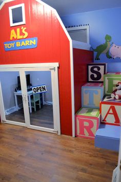 this is a kid's playroom made out of wooden blocks and painted red