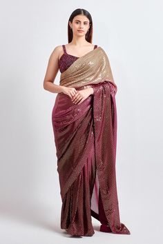 Wine and gold ombre base saree highlighted by sequin embellishments. Comes with matching padded embroidered blouse.
Components: 2
Pattern: Embroidered
Type Of Work: Thread,Sequin,Crystal
Neckline: V-neck
Sleeve Type: Sleeveless
Fabric: Georgette Embroidery
Color: Wine,Gold
Other Details: 
Attached lining
Weight: 1.5 kgs
 Length: Blouse: 14 inches
Model Height: 5 ft 9 inches, wearing size M
Occasion: Sangeet,Reception - Aza Fashions Glamorous Pre-draped Saree With Resham Embroidery For Reception, Festive Gold Embellished Pre-draped Saree, Bollywood Style Embellished Festive Pre-draped Saree, Gold Pre-draped Saree With Resham Embroidery For Evening, Diwali Sequined Pre-draped Saree, Glamorous Sequined Pre-draped Saree For Festivals, Glamorous Designer Pre-draped Saree For Navratri, Party Wear Pre-draped Sequined Saree For Festivals, Glamorous Embellished Pre-draped Saree For Celebrations